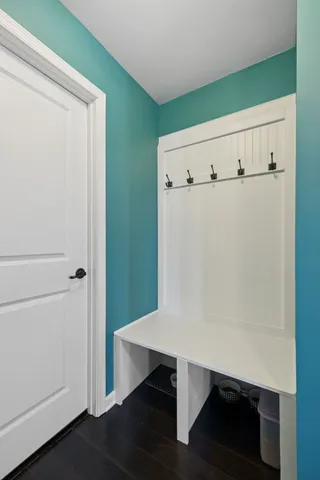 a view of a hallway with wooden floor and stairs
