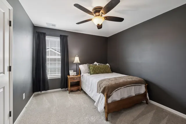 a bedroom with furniture and a window