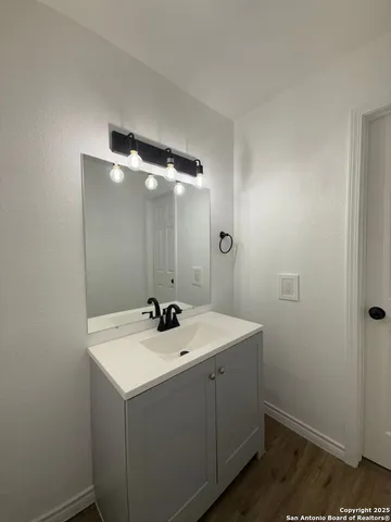 a bathroom with a sink and mirror