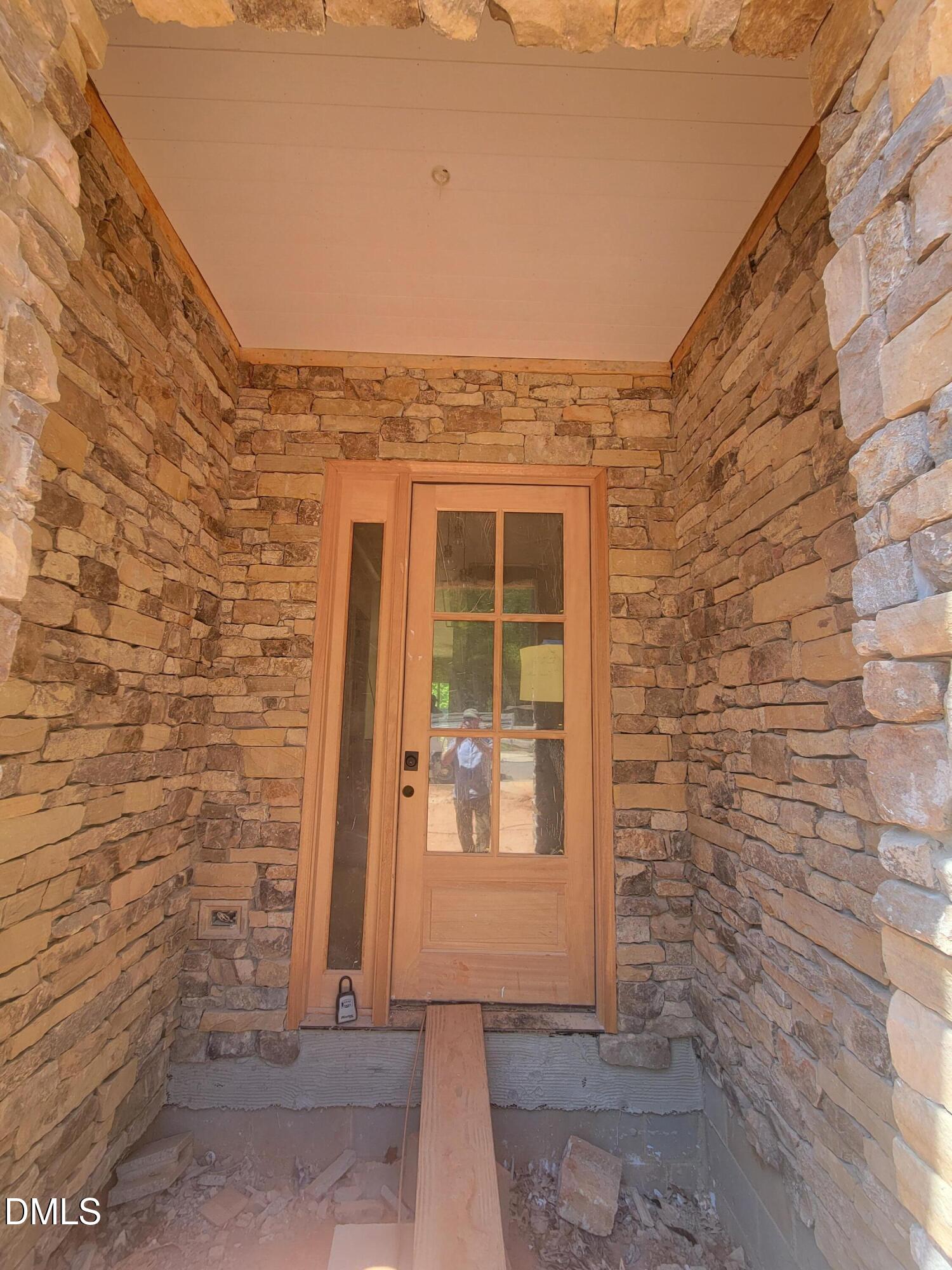 8721 Little Deer Lane Raleigh, NC 27613 - Photo 7 of 25 a view of a brick house with a door