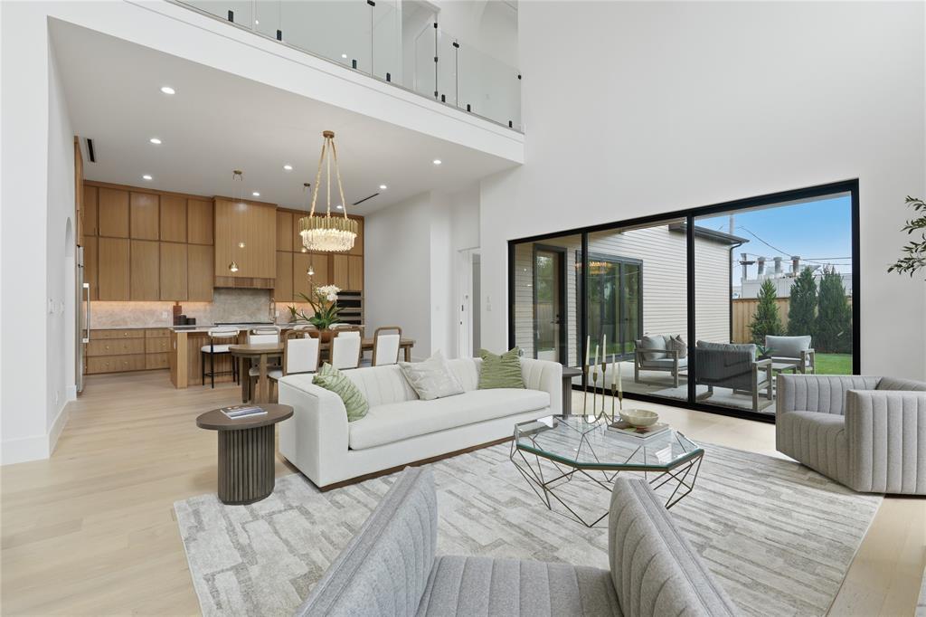 6038 Prospect Avenue Dallas, TX 75206 - Photo 25 of 40 Open-concept living area with soaring ceilings and light wood-finish flooring