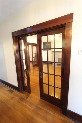a view of an empty room with a fireplace and a window