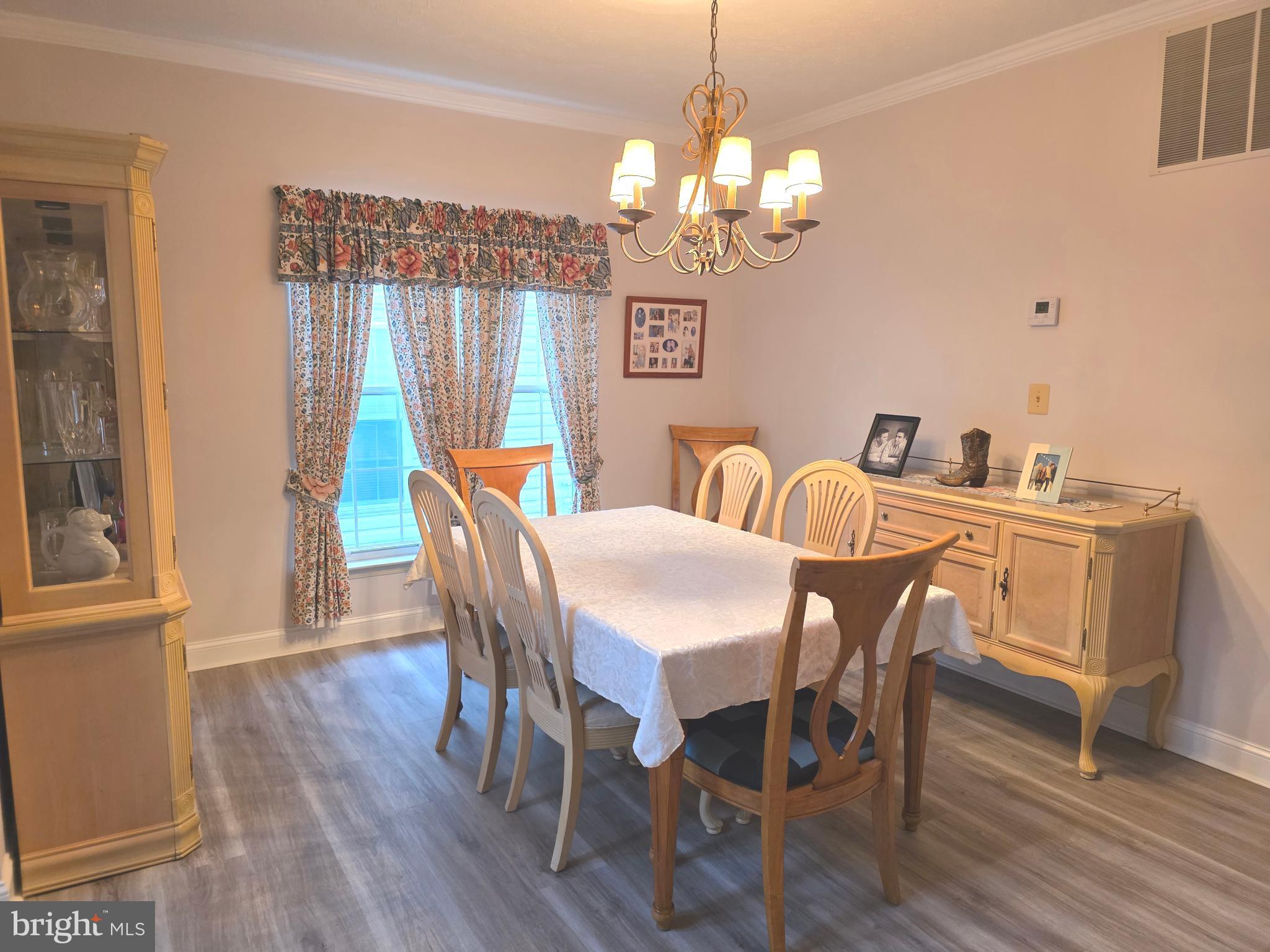 2441 Kemper Road Crofton, MD 21114 - Photo 8 of 63 a view of a dining room with furniture wooden floor and chandelier