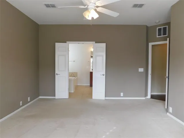 a view of a livingroom with a chandelier fan