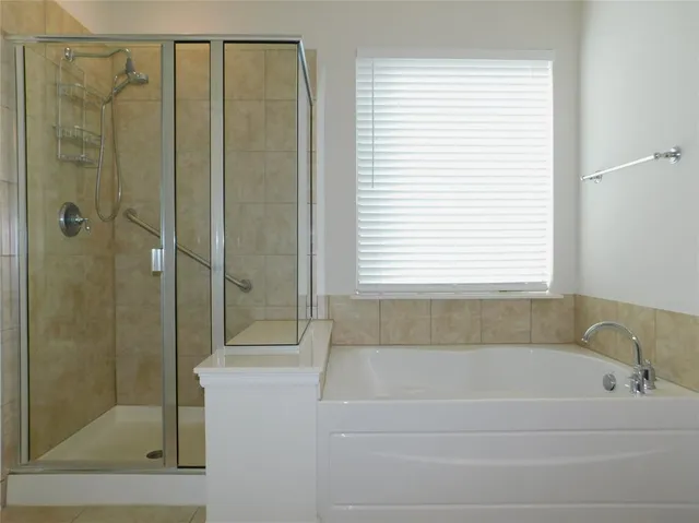 a bathroom with a bathtub and shower