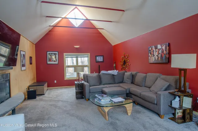 a living room with furniture a lamp and a potted plant