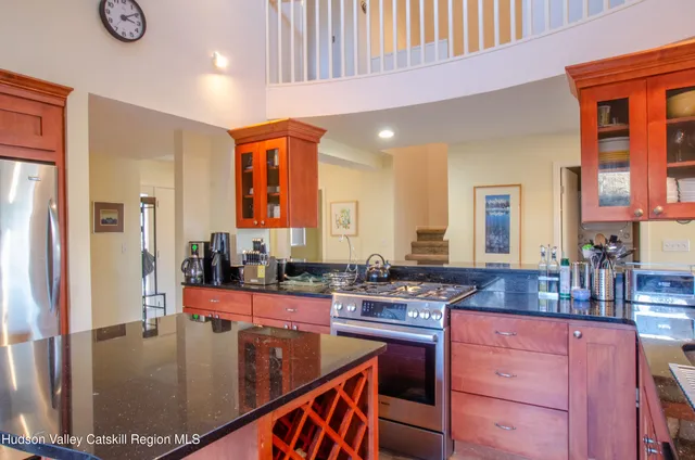a kitchen with stainless steel appliances granite countertop a stove a sink and a refrigerator