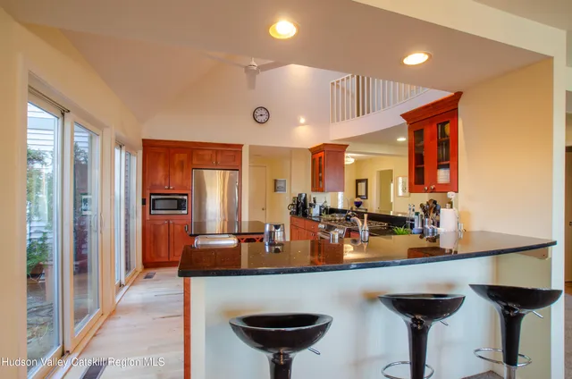 a view of a kitchen with a sink and a refrigerator