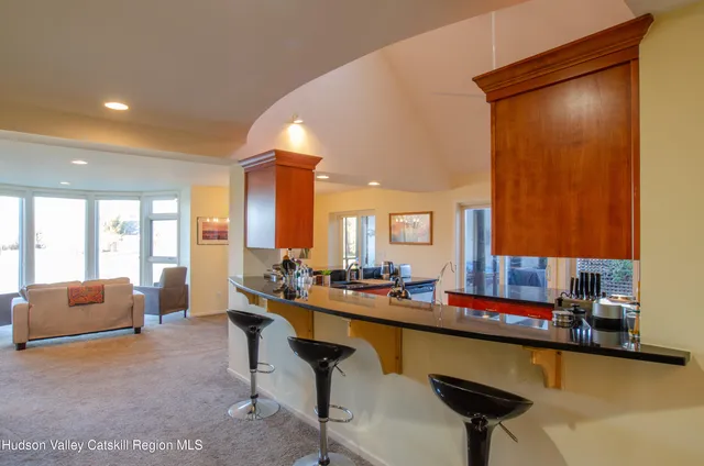 a living room with furniture and a pool table