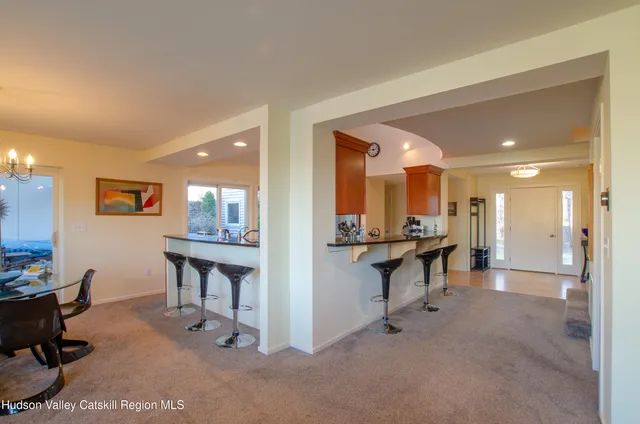 a view of a lobby area with dining room and wooden floor