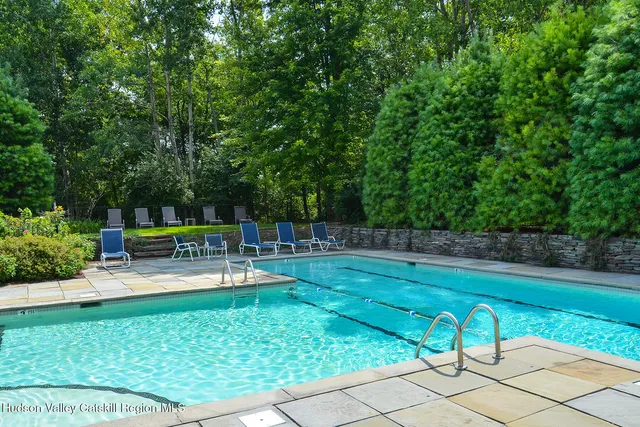 a view of backyard with seating and trees