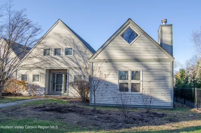 a view of house with a yard