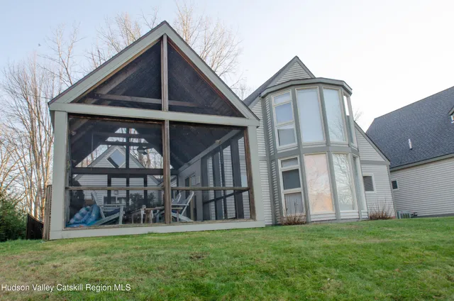 a view of a house with a yard and a garden