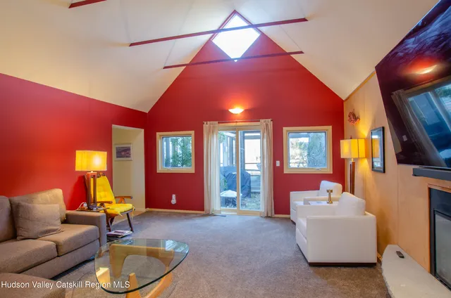 a living room with furniture a window and gym equipment