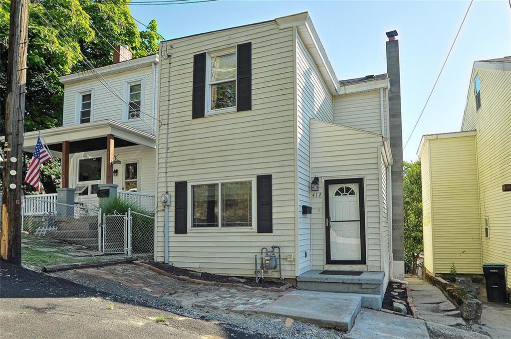 a view of a house with a backyard