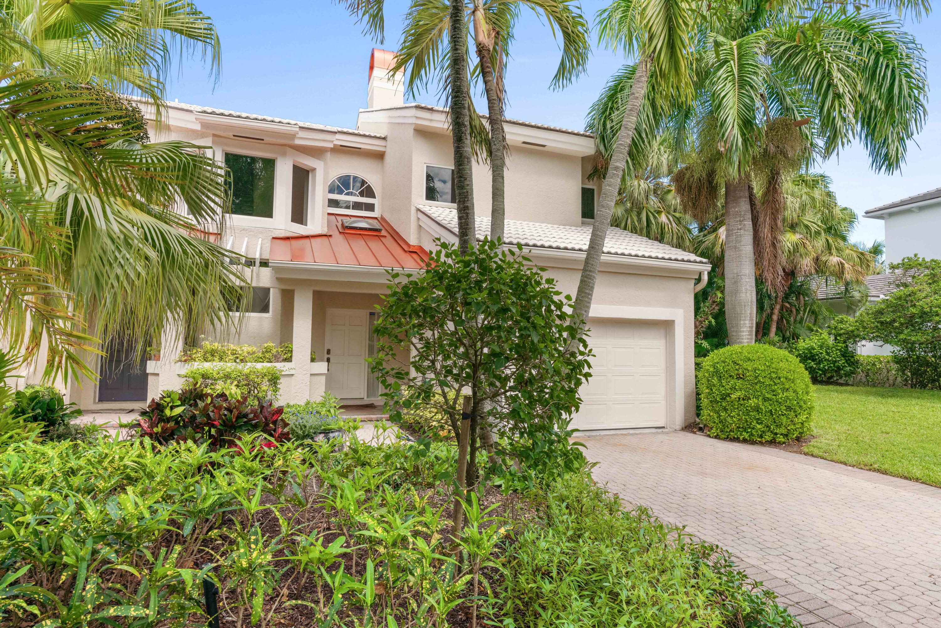 266 Eagle Drive Jupiter, FL 33477 - Photo 1 of 35 a front view of a house with garden