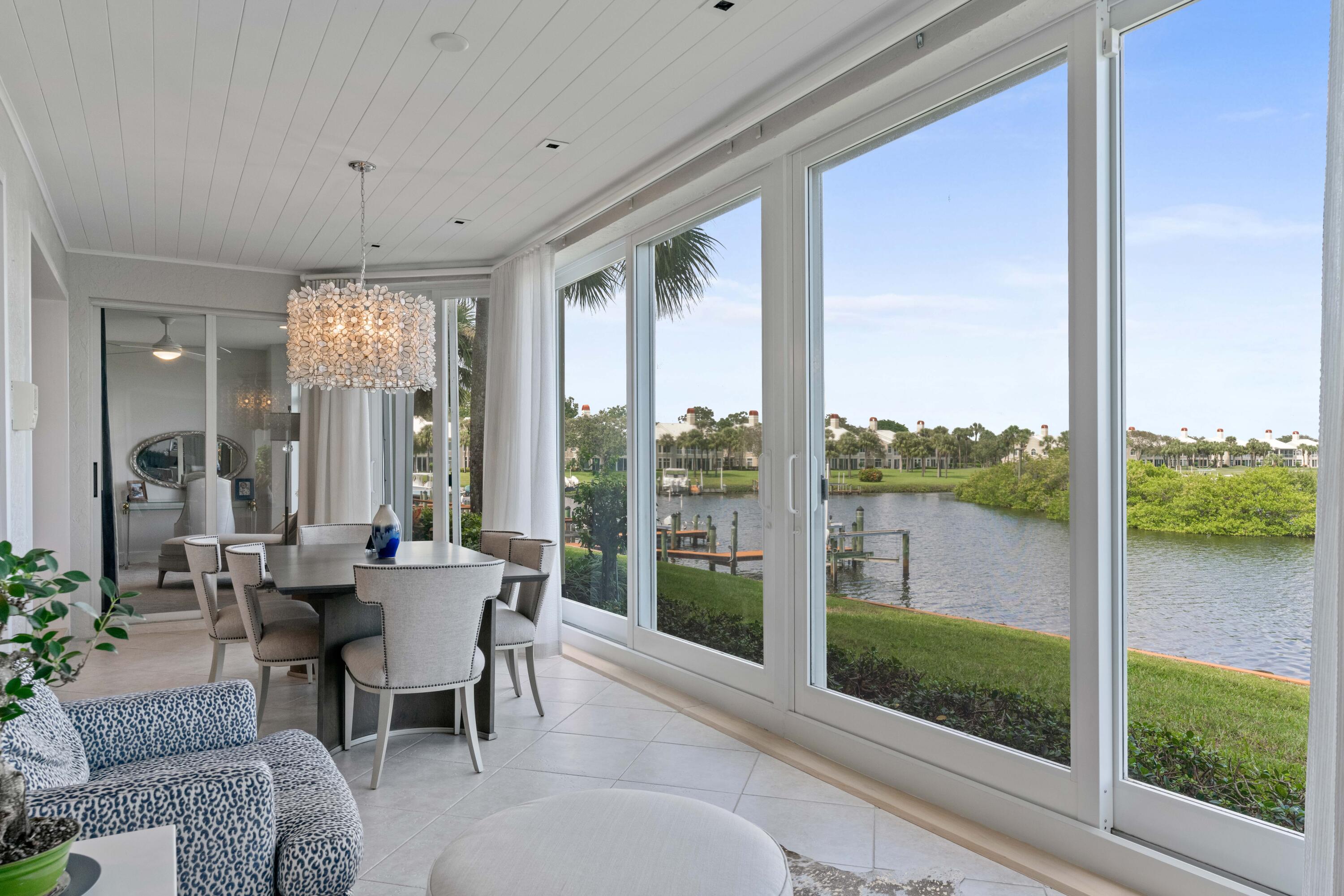 266 Eagle Drive Jupiter, FL 33477 - Photo 11 of 35 a dining room with furniture wooden floor and a rug