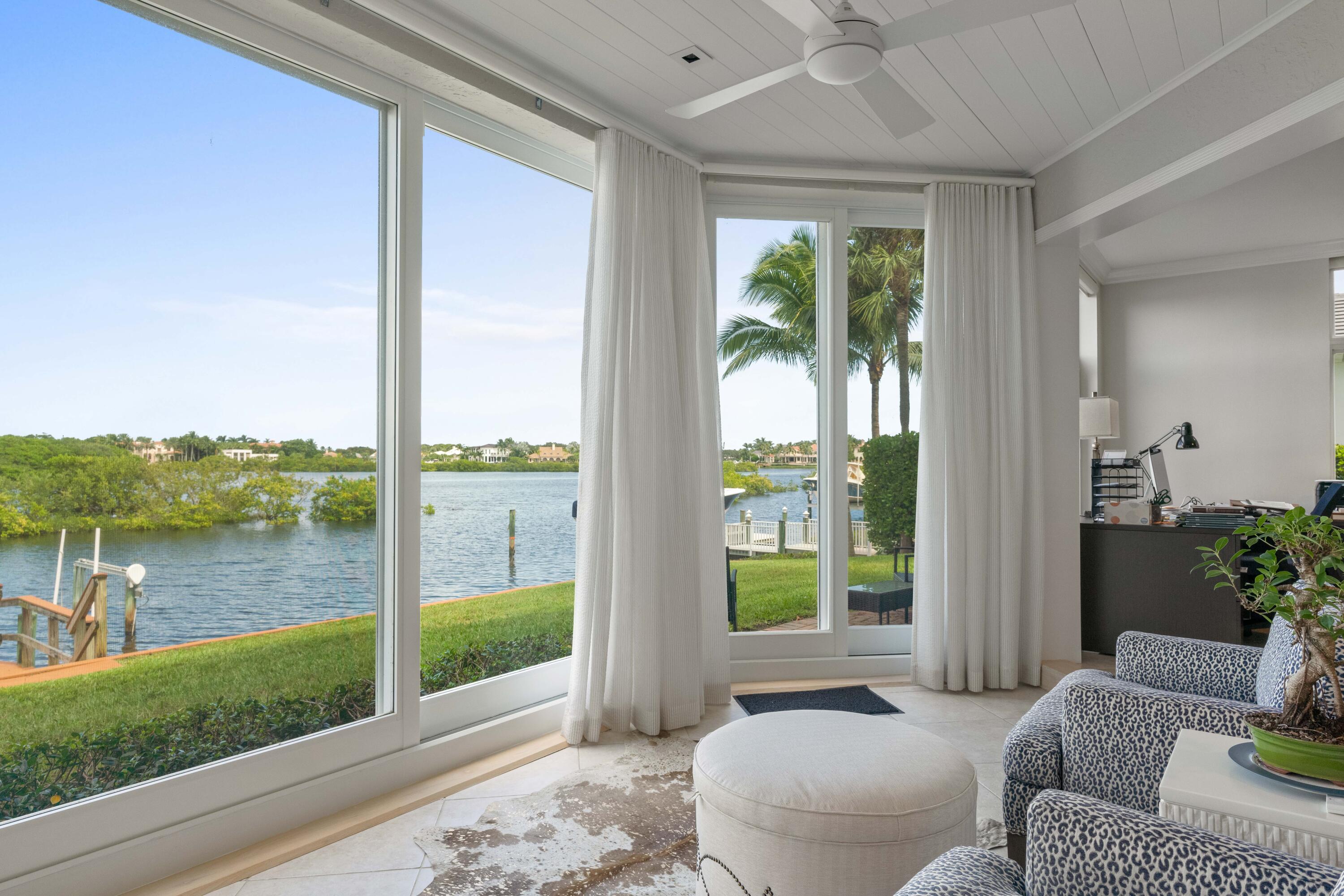 266 Eagle Drive Jupiter, FL 33477 - Photo 12 of 35 a living room with furniture and a floor to ceiling window