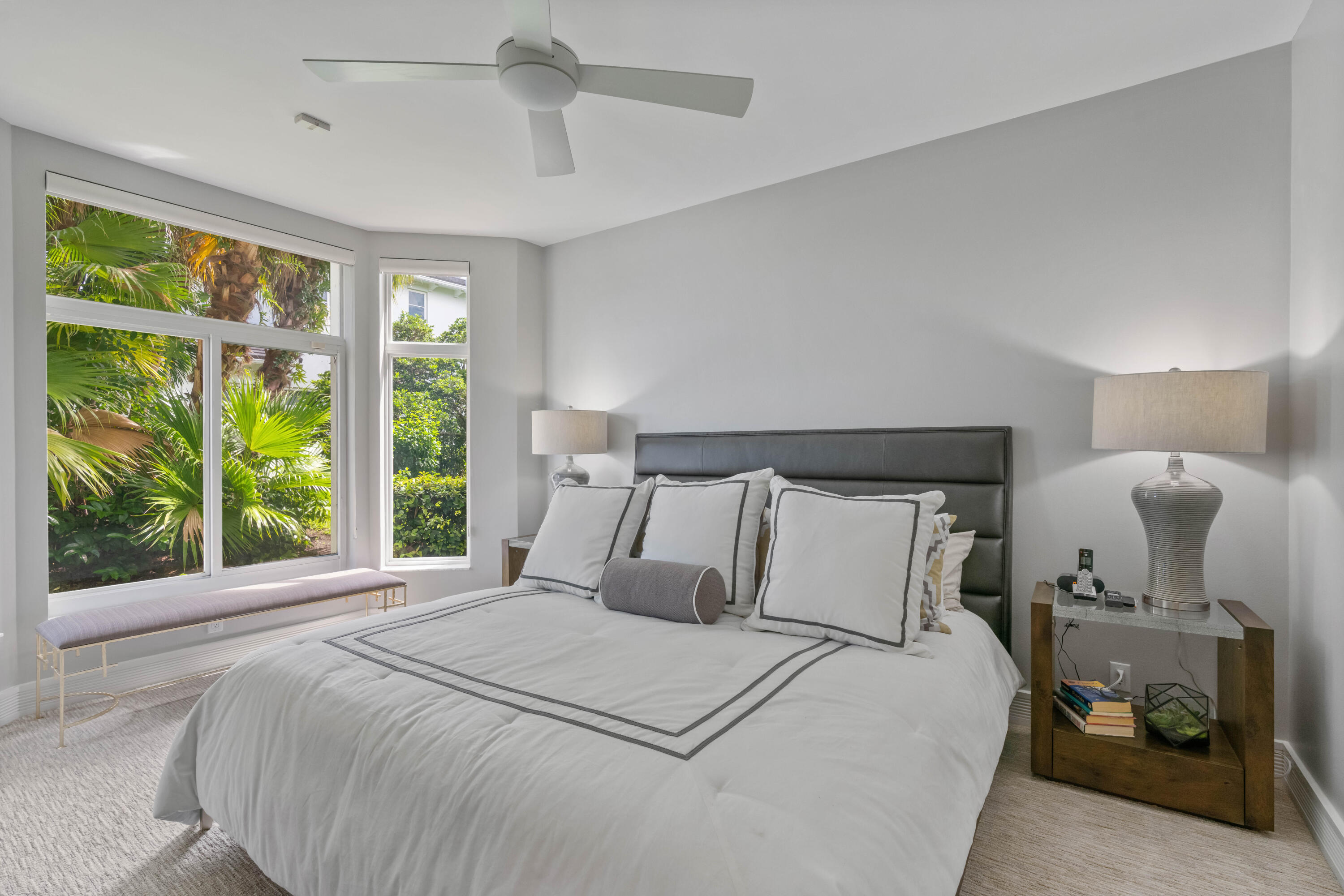 266 Eagle Drive Jupiter, FL 33477 - Photo 17 of 35 a bedroom with a bed and large windows