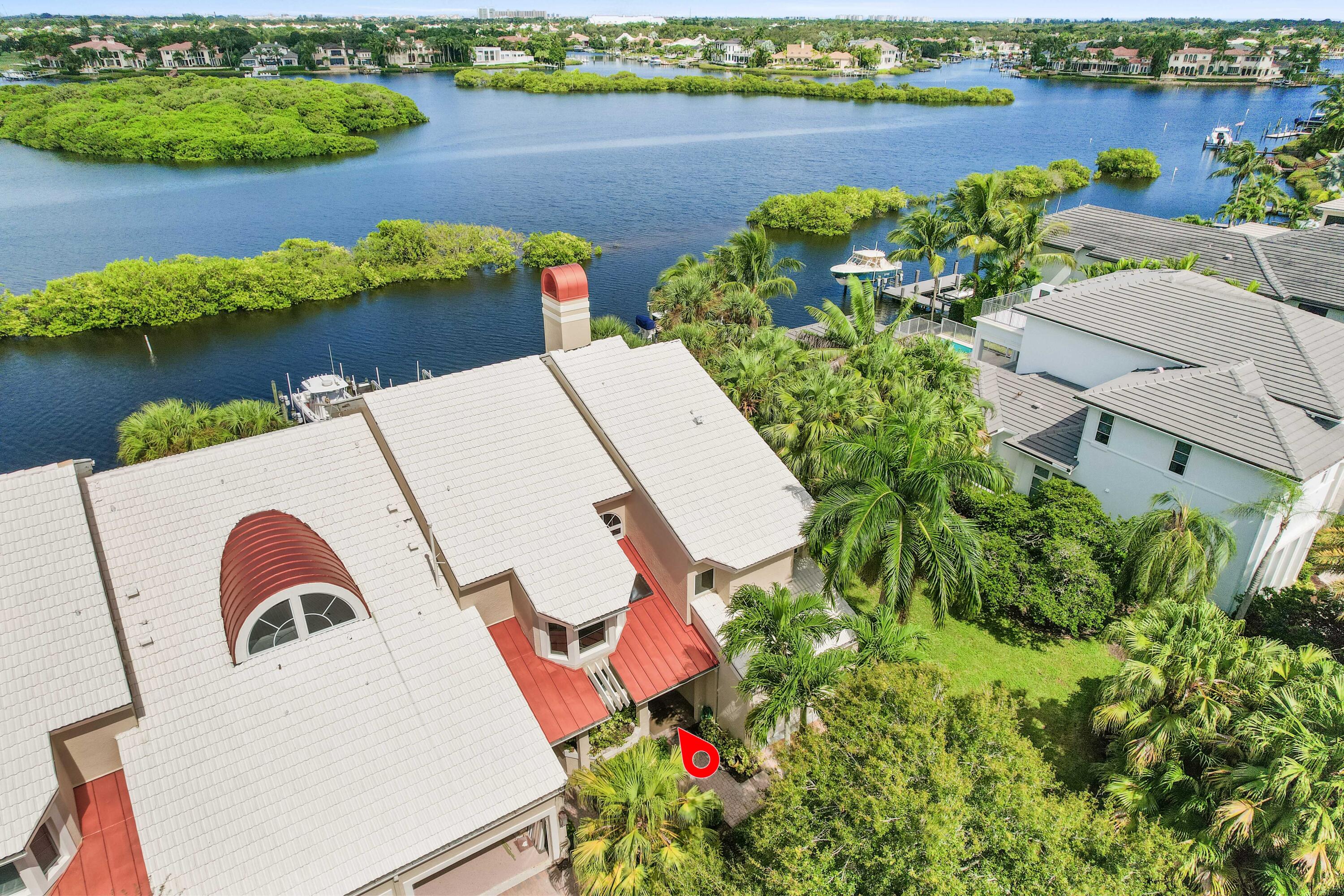 266 Eagle Drive Jupiter, FL 33477 - Photo 20 of 35 an aerial view of a house with swimming pool and lake view