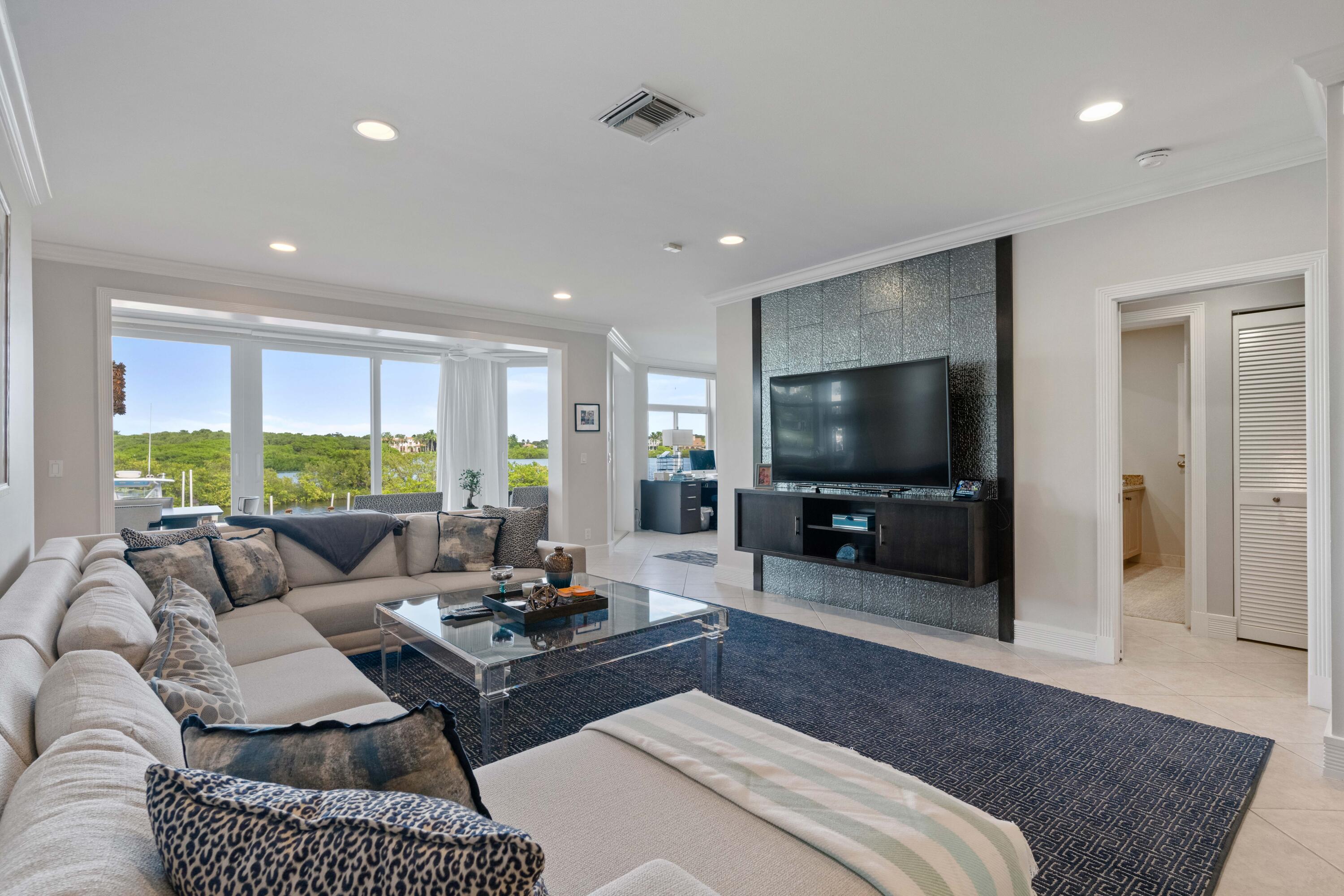 266 Eagle Drive Jupiter, FL 33477 - Photo 2 of 35 a living room with furniture and a flat screen tv
