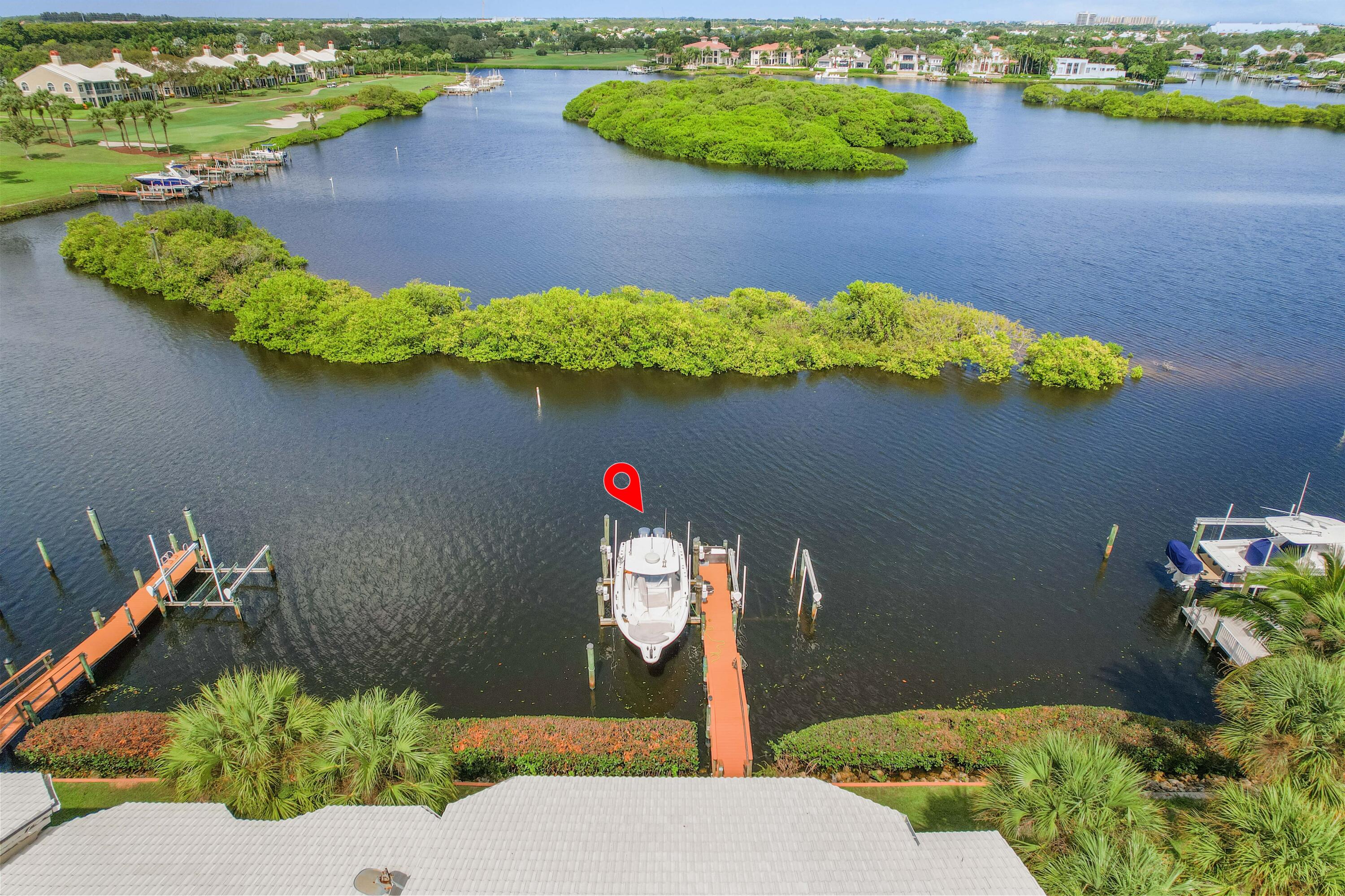 266 Eagle Drive Jupiter, FL 33477 - Photo 21 of 35 a front view of a house with a yard and plants
