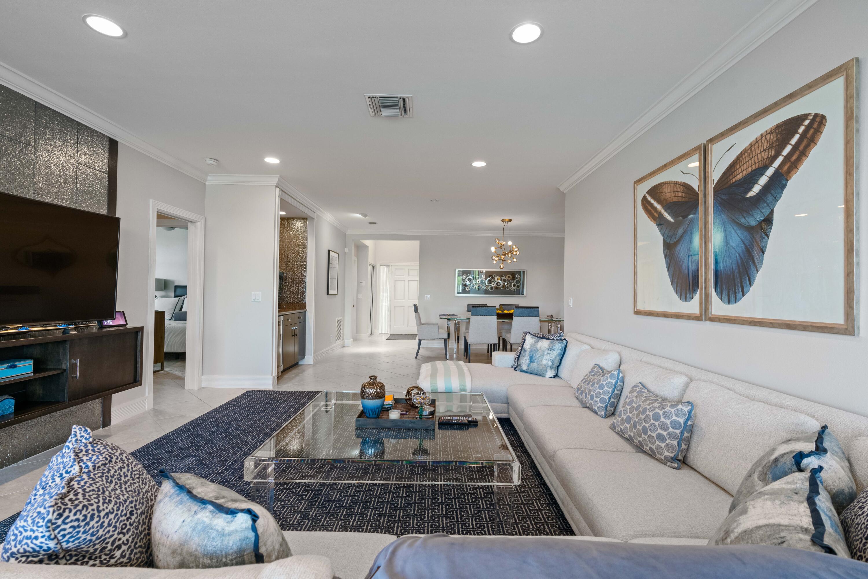 266 Eagle Drive Jupiter, FL 33477 - Photo 3 of 35 a living room with furniture and a flat screen tv