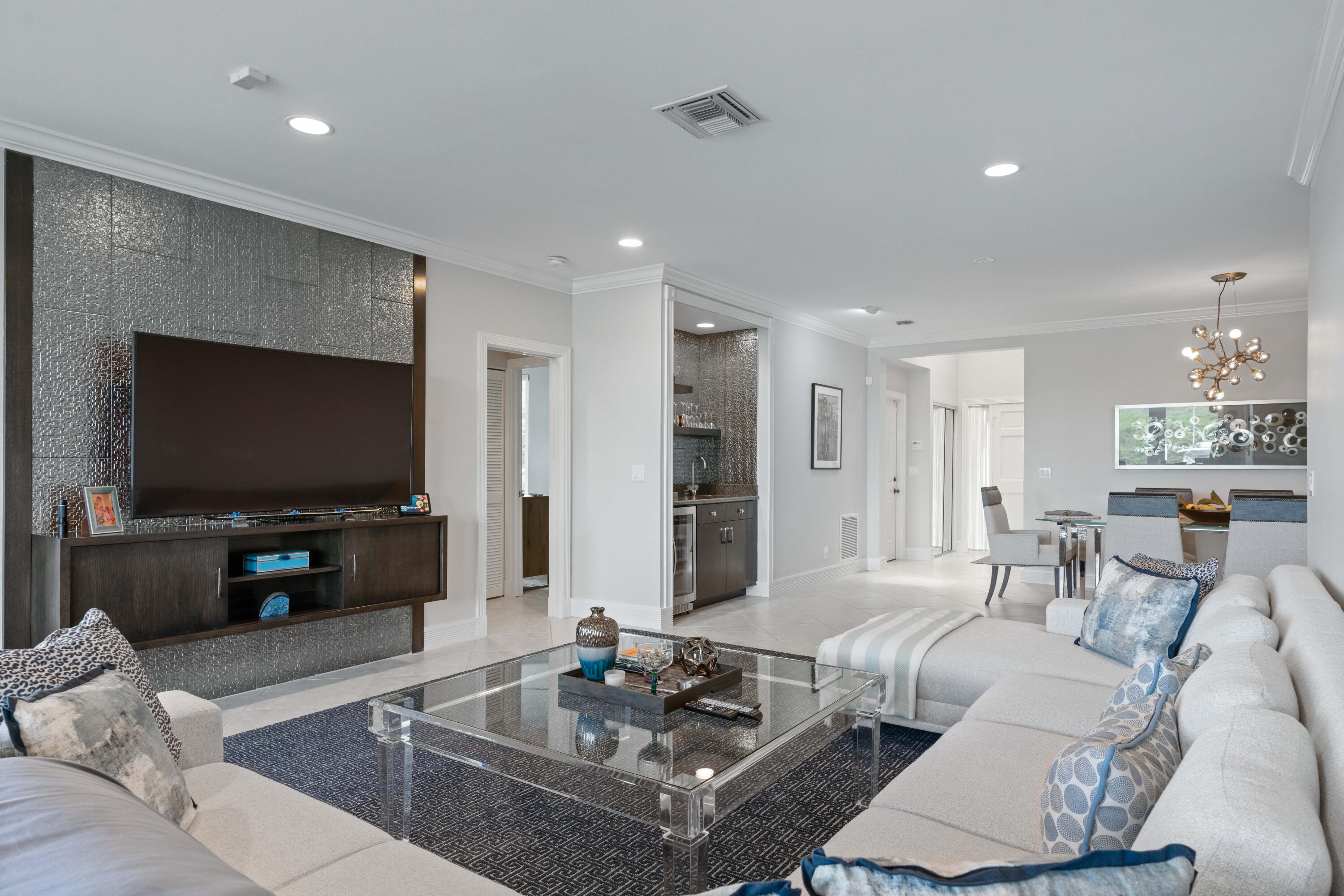 266 Eagle Drive Jupiter, FL 33477 - Photo 4 of 35 a living room with furniture and a flat screen tv