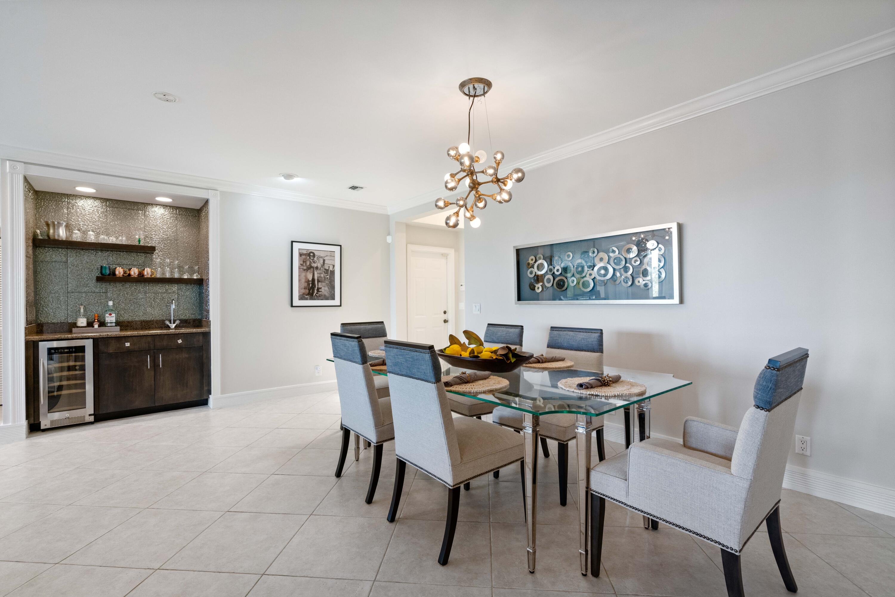 266 Eagle Drive Jupiter, FL 33477 - Photo 6 of 35 a view of a dining room with furniture and wooden floor