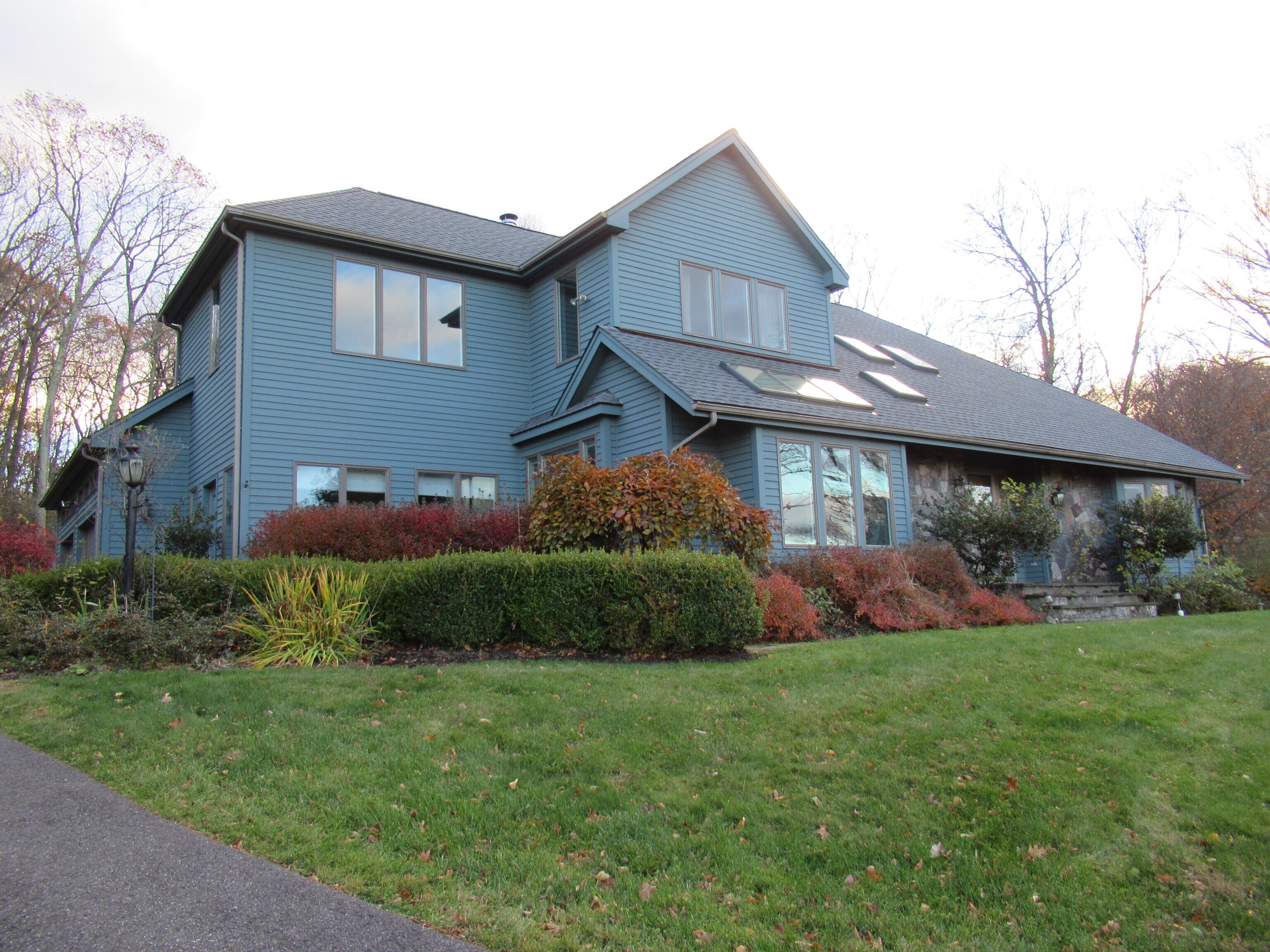 a front view of a house with a yard and potted plants