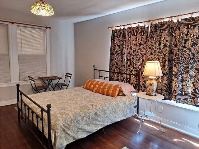 a bedroom with bed and window