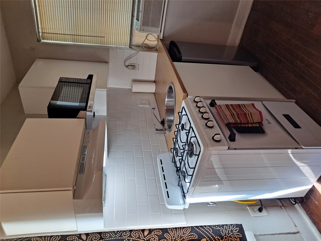 1906 San Gabriel Street, Unit 14 Austin, TX 78705 - Photo 6 of 8 a white stove top oven sitting inside of a kitchen