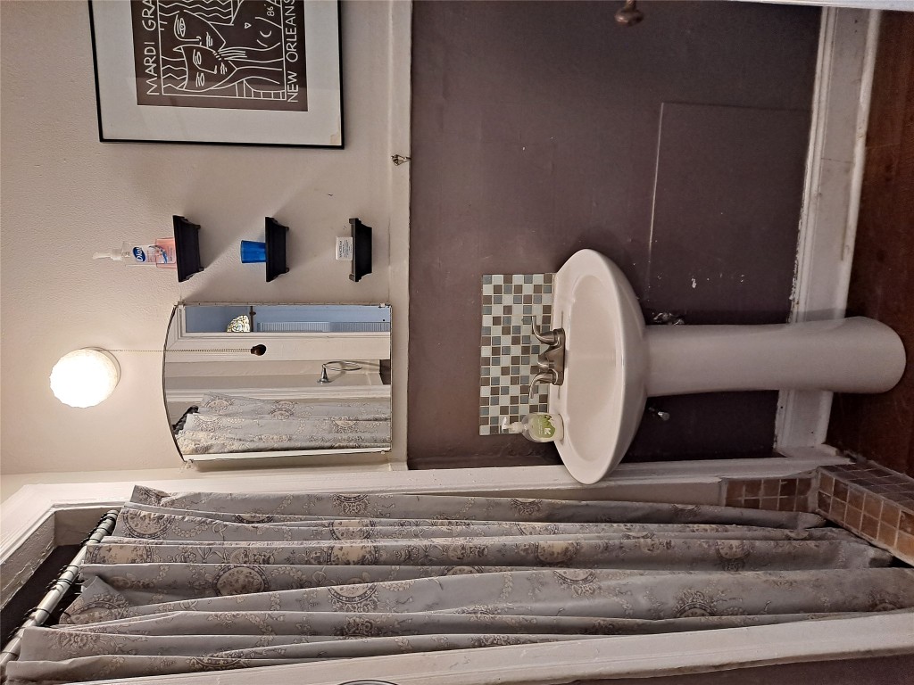 1906 San Gabriel Street, Unit 14 Austin, TX 78705 - Photo 7 of 8 a bathroom with a sink and a mirror