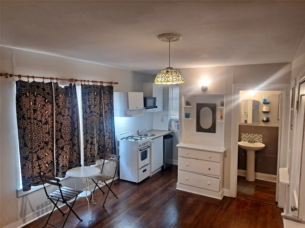1906 San Gabriel Street, Unit 14 Austin, TX 78705 - Photo 8 of 8 a kitchen with stainless steel appliances a stove and a refrigerator