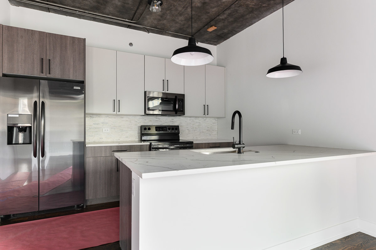 4720 North Sheridan Road, Unit 3D Chicago, IL 60640 - Photo 4 of 15 a kitchen with stainless steel appliances a refrigerator a sink a stove and cabinets