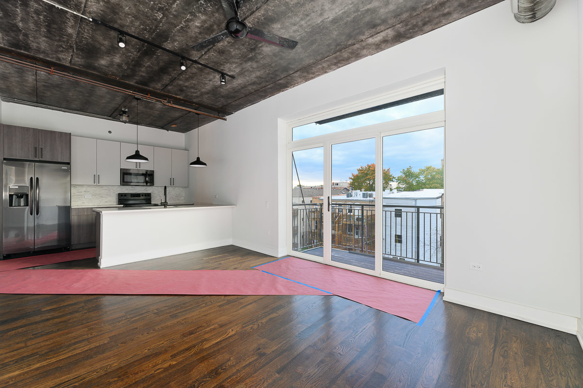 4720 North Sheridan Road, Unit 3D Chicago, IL 60640 - Photo 5 of 15 a view of kitchen with furniture and wooden floor