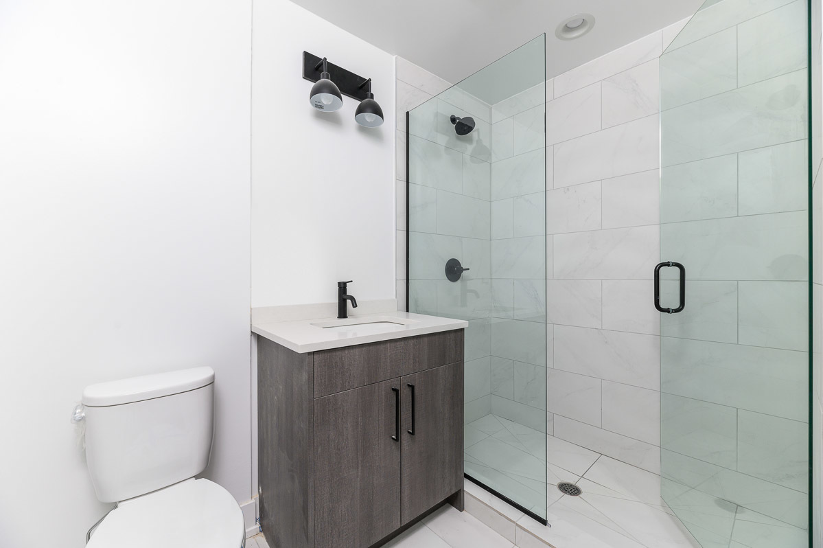 4720 North Sheridan Road, Unit 3D Chicago, IL 60640 - Photo 7 of 15 a bathroom with a toilet sink and shower