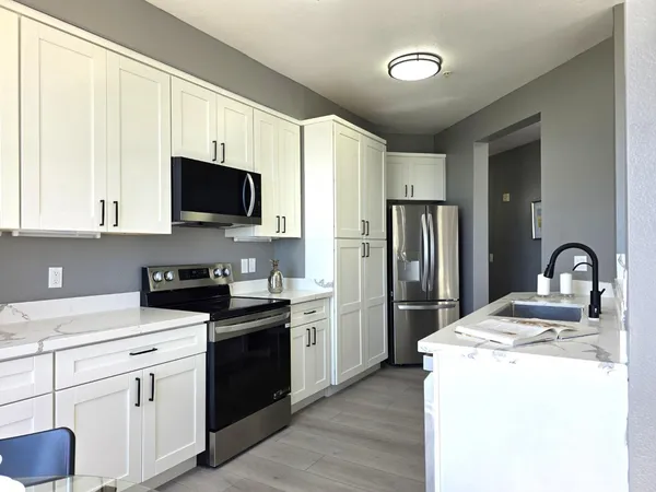 a kitchen with a sink a stove and refrigerator