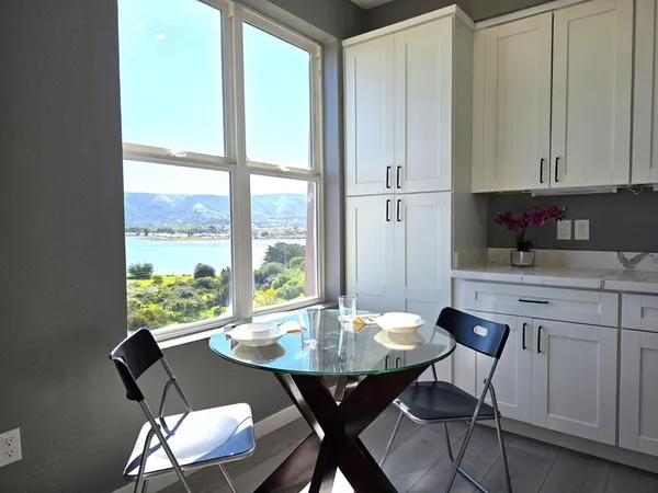 a view of a dining room with furniture and window