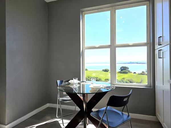 a view of a dining room with a table and chairs
