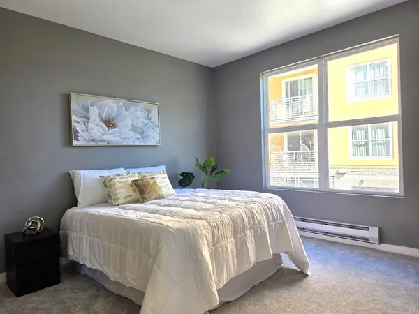 a bedroom with a bed and a window