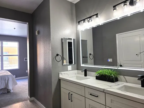 a bathroom with a double vanity sink and a mirror