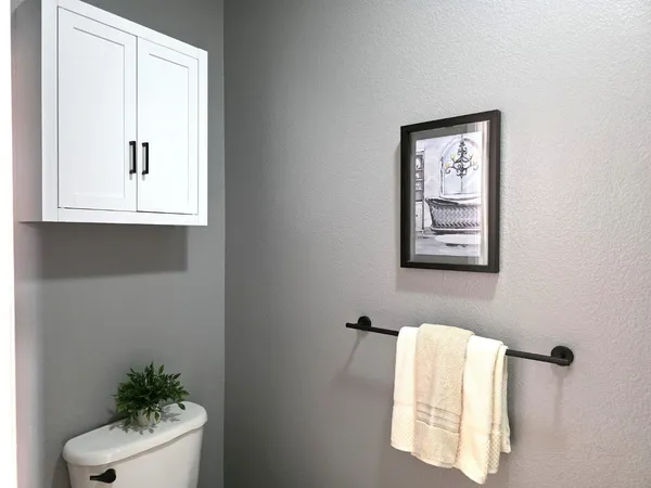 a bathroom with a window and a potted plant