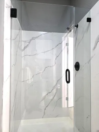 a bathroom with a shower and a glass door shower