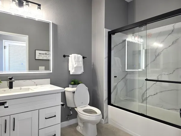 a bathroom with a sink toilet and shower