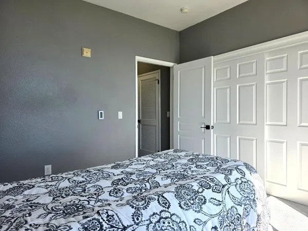 a bedroom with a bed and a window