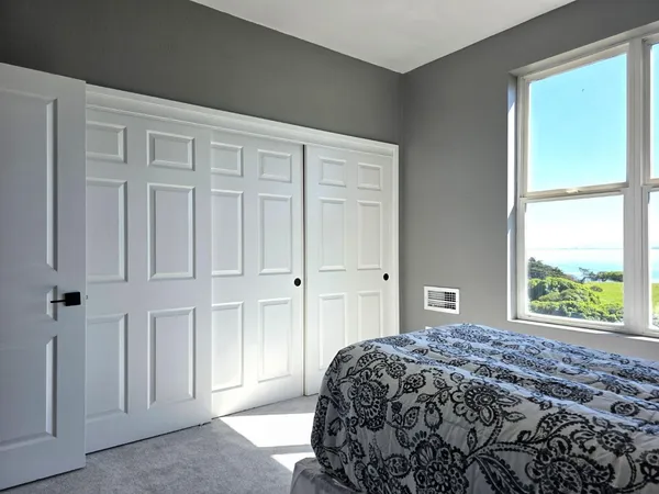 a bedroom with a bed and a window
