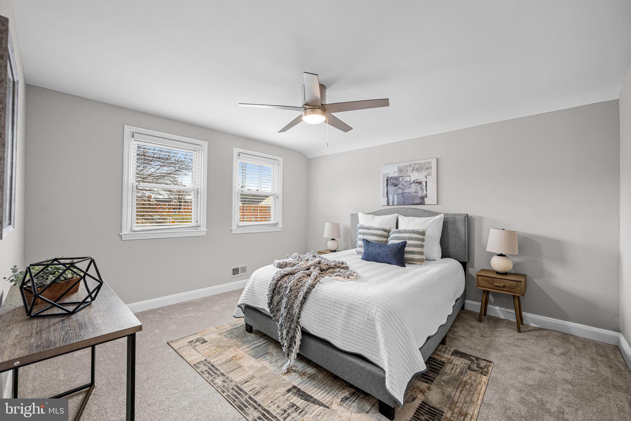 1935 Ramblewood Road Baltimore, MD 21239 - Photo 18 of 37 a bedroom with a bed and a chandelier