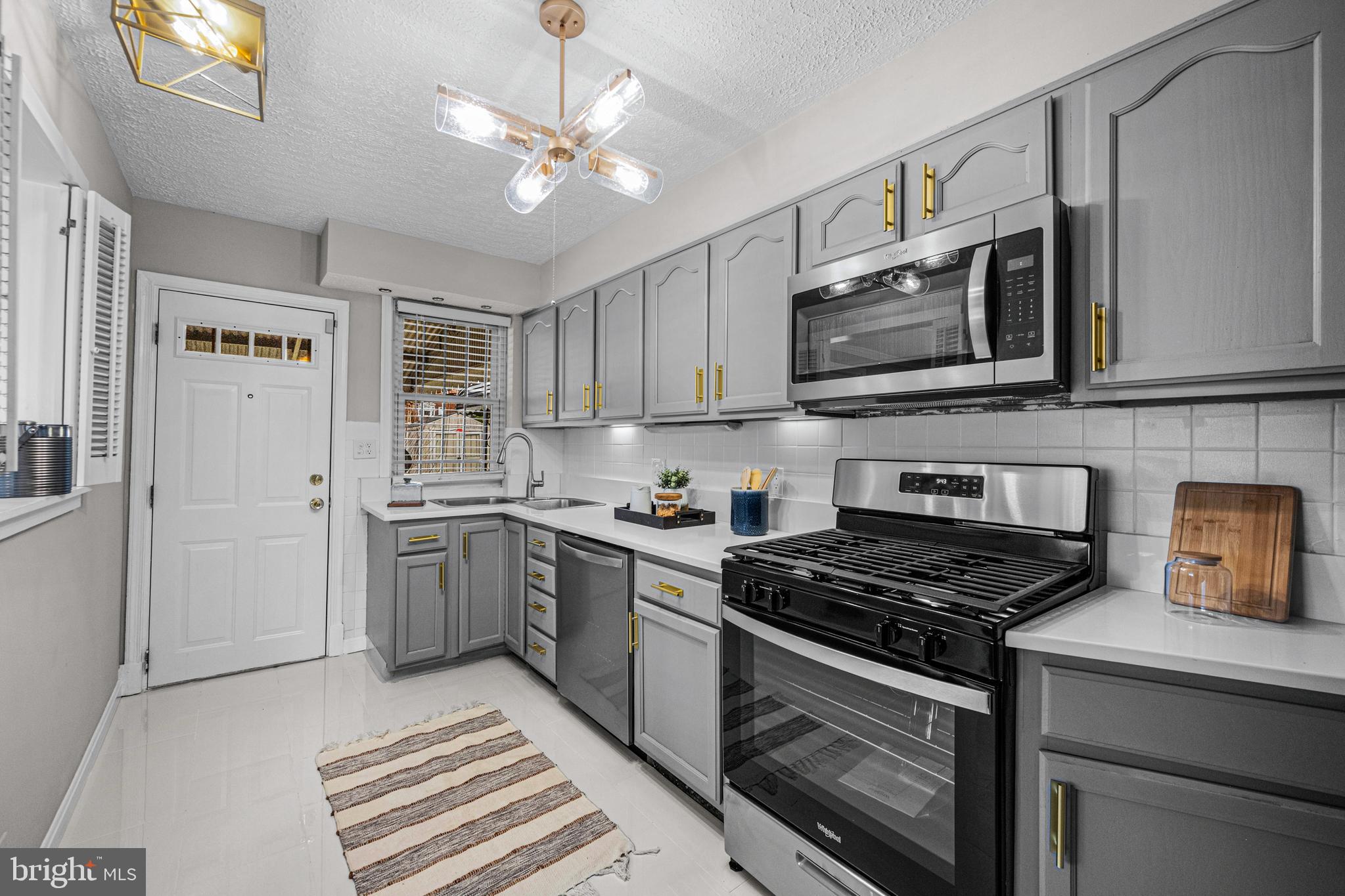 1935 Ramblewood Road Baltimore, MD 21239 - Photo 2 of 37 a kitchen with stainless steel appliances granite countertop a stove a sink and a microwave