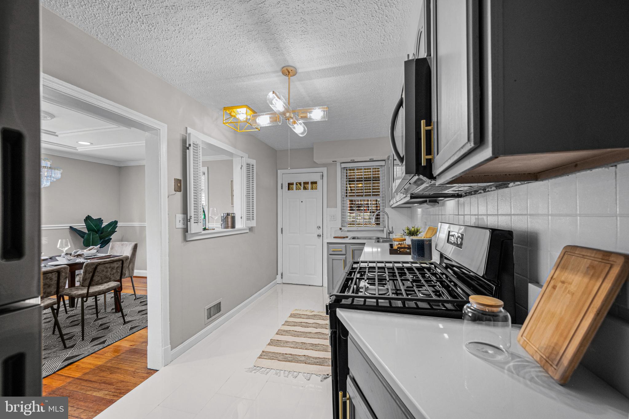 1935 Ramblewood Road Baltimore, MD 21239 - Photo 3 of 37 a kitchen with furniture a stove and a view of kitchen